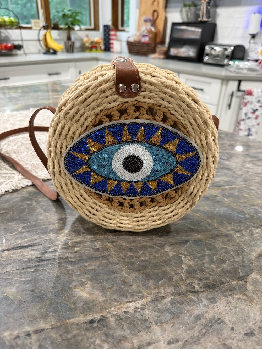 Handwoven Round Crossbody Bag with Beaded Evil Eye - Natural Straw & Blue Accent